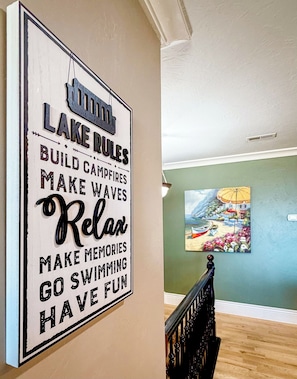 Charming lakeside-inspired hallway with playful decor and warm finishes