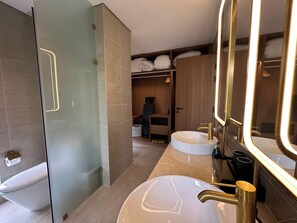 A modern bathroom with a glass shower enclosure, a large vanity with a gold faucet, and a round sink. - Wyndham Hoi An Royal Beachfront Resort (Hoi An)