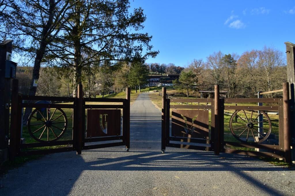 A gated entrance with a pathway leading to a building.