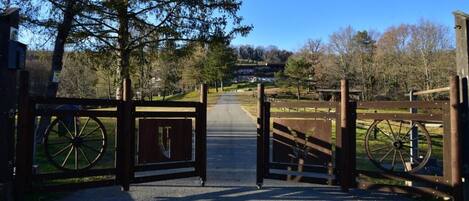 A gated entrance with a pathway leading to a building.
