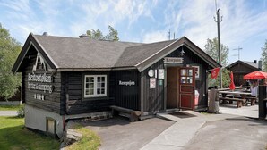 A wooden building with a reception area, labeled "Beitostolen hytter & camping," and a sign indicating "Reception." - First Camp Beitostølen - Valdres (Beitostølen)
