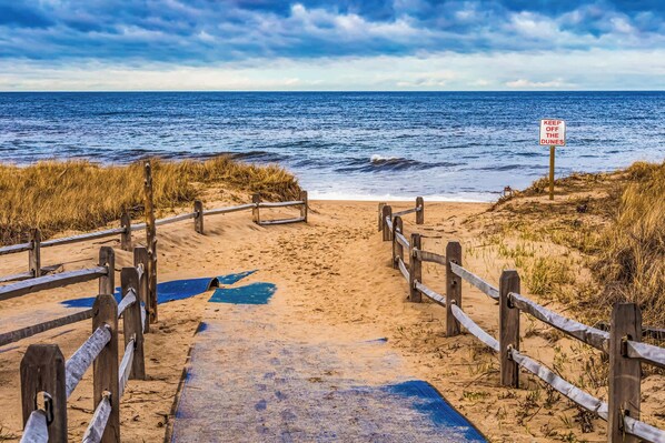 A wooden boardwalk leading to a beach with a sign reading "KEEP OFF THE DUNES". - Game Room, Cozy & Mins to Beaches! (Eastham)