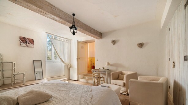 A bedroom with a large bed, a desk, a chair, and a wardrobe. - “L'Étable” Guest Room with Shared Terrace & Garden, Wi-Fi, Breakfast, Pool Access (Rieucros)