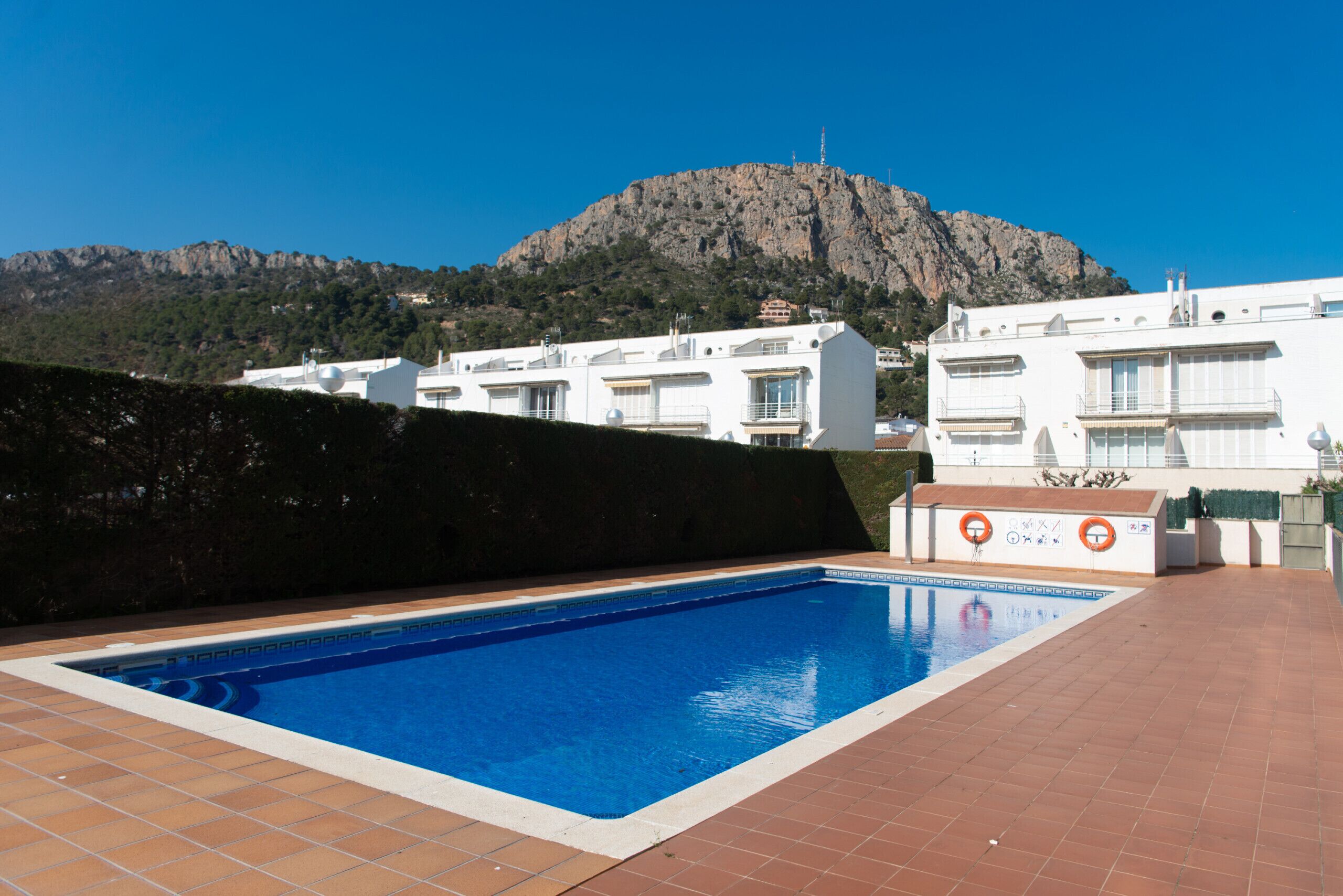 A swimming pool with a mountain in the background.