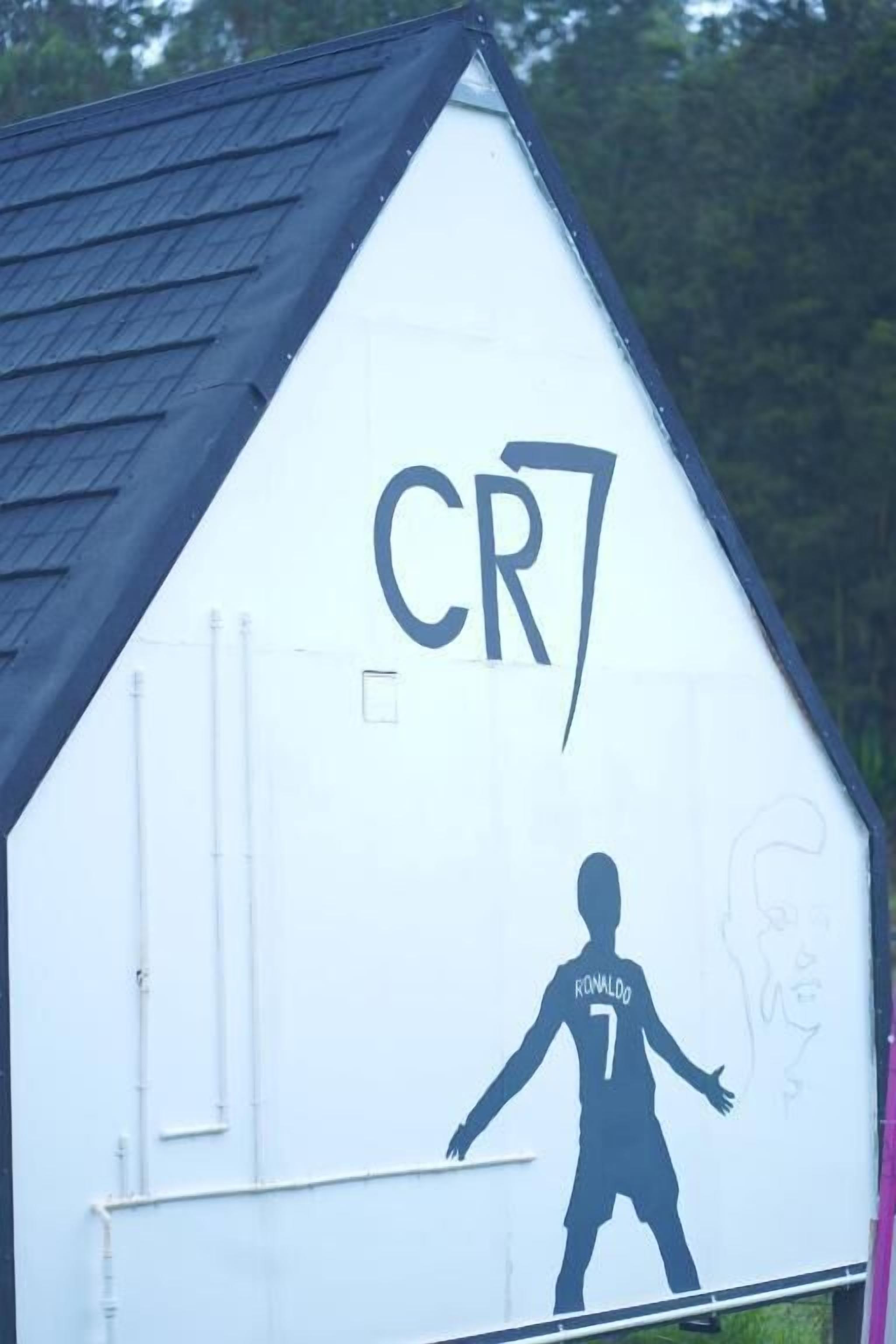 A building with a triangular roof and a large 'CR7' sign on the side.