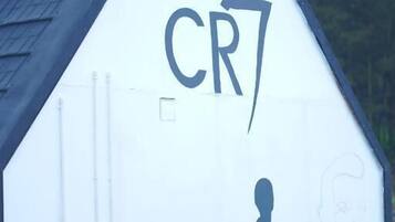 A building with a triangular roof and a large 'CR7' sign on the side.
