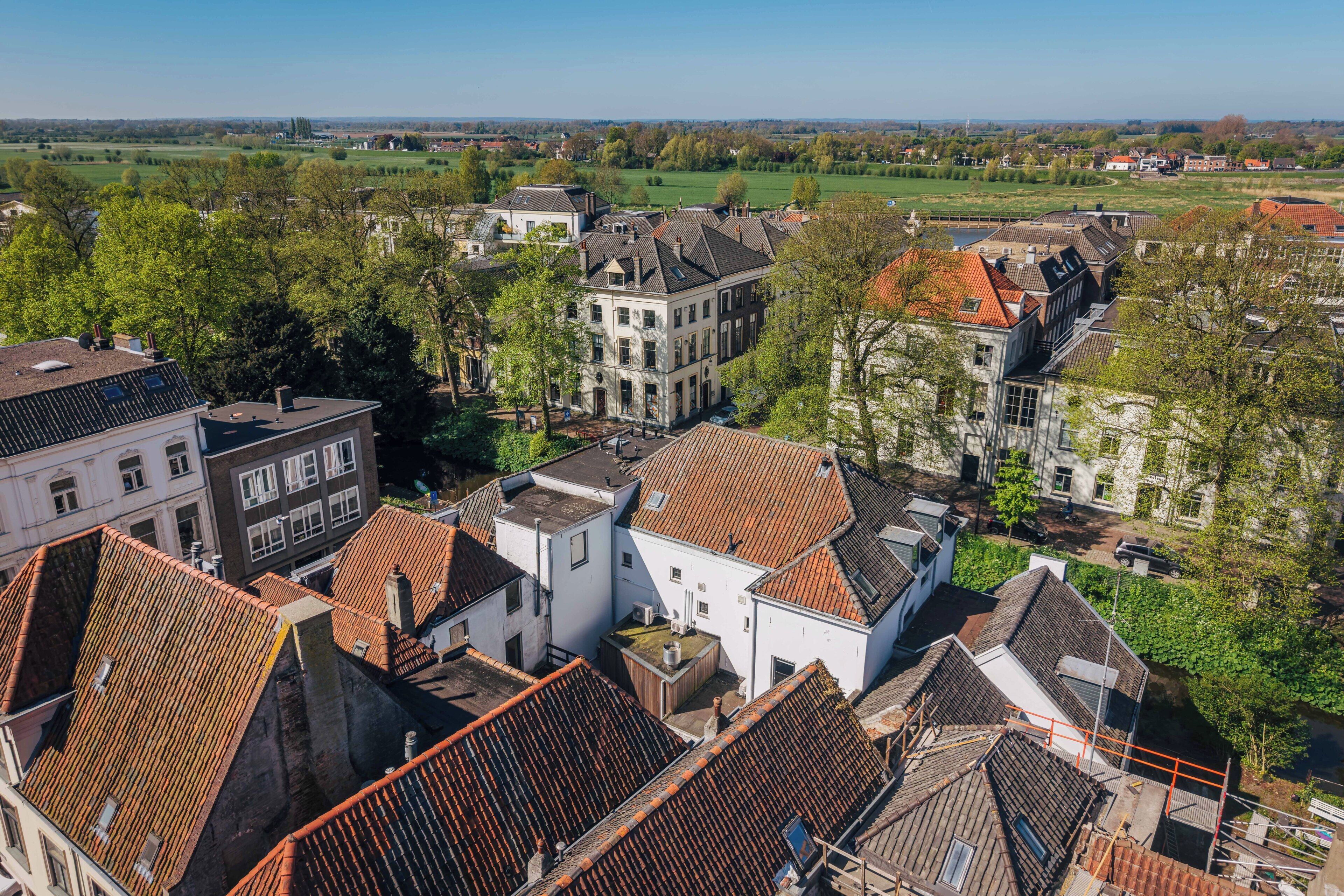 A residential area with traditional architecture, including buildings with tiled roofs and a mix of window styles.