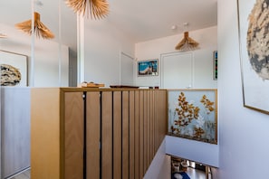 A modern interior with a wooden partition, a framed botanical print, and pendant lighting. - Double Room 'Coquelicot' with Saltwater Pool, Shared Terrace & Garden (Parentis-en-Born)