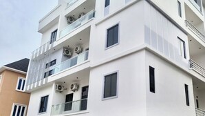 A multi-story building with balconies, air conditioning units, and a modern architectural design. - Vievely Suites and Apartments (Lagos)