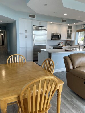 A modern kitchen with white cabinets, stainless steel appliances, and a central island. - Spectacular 3BR Condo - Great views of the inlet & ocean in Palm Beach Shores (Palm Beach Shores)