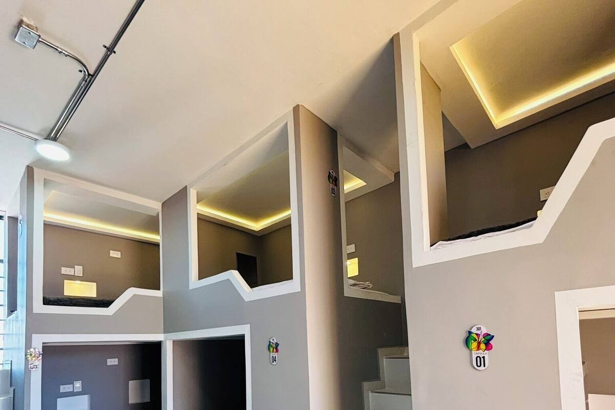 A room with bunk beds, a staircase, and a green tiled floor.