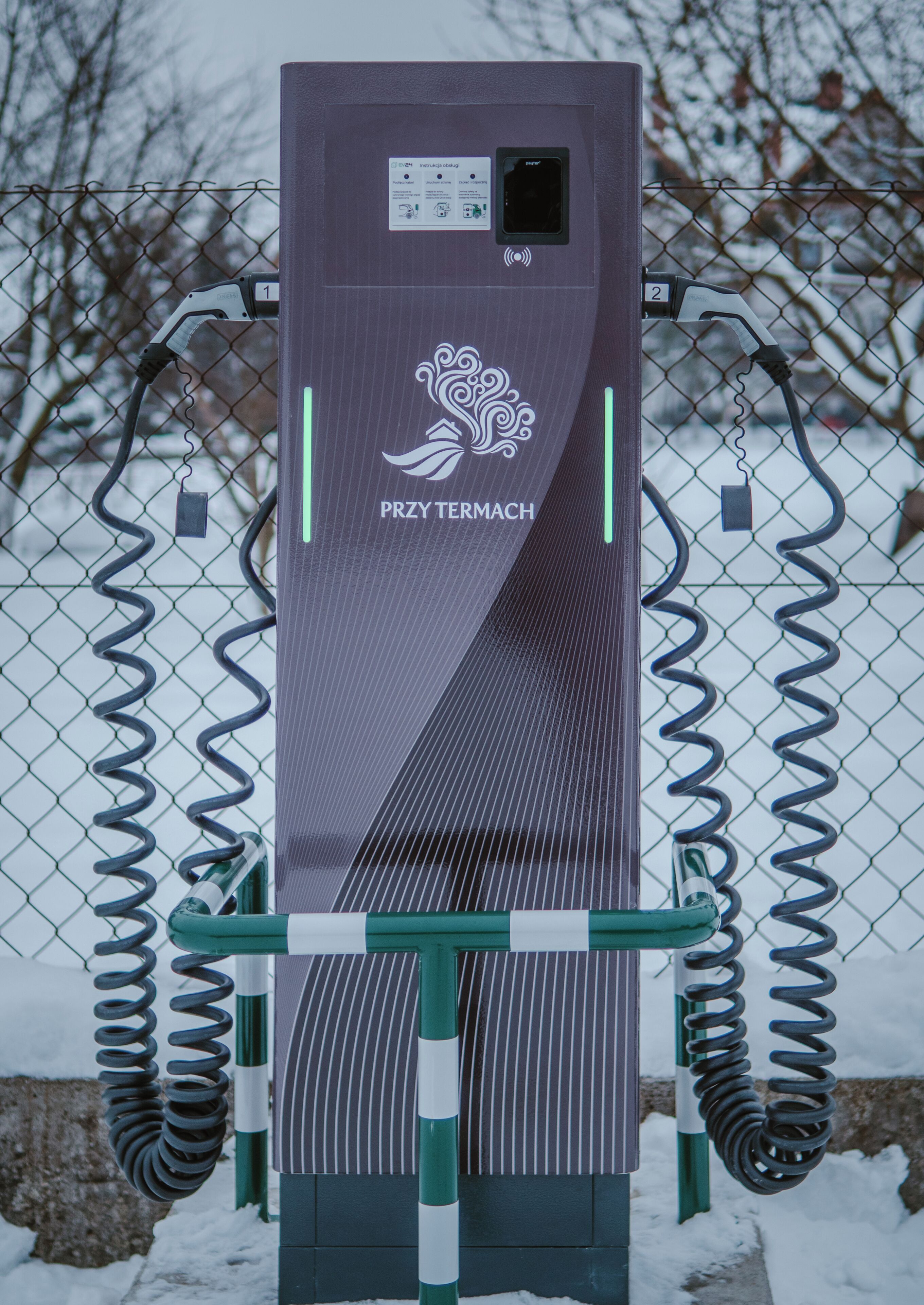 A portable power station with a charging cable, a plug, and a display screen.