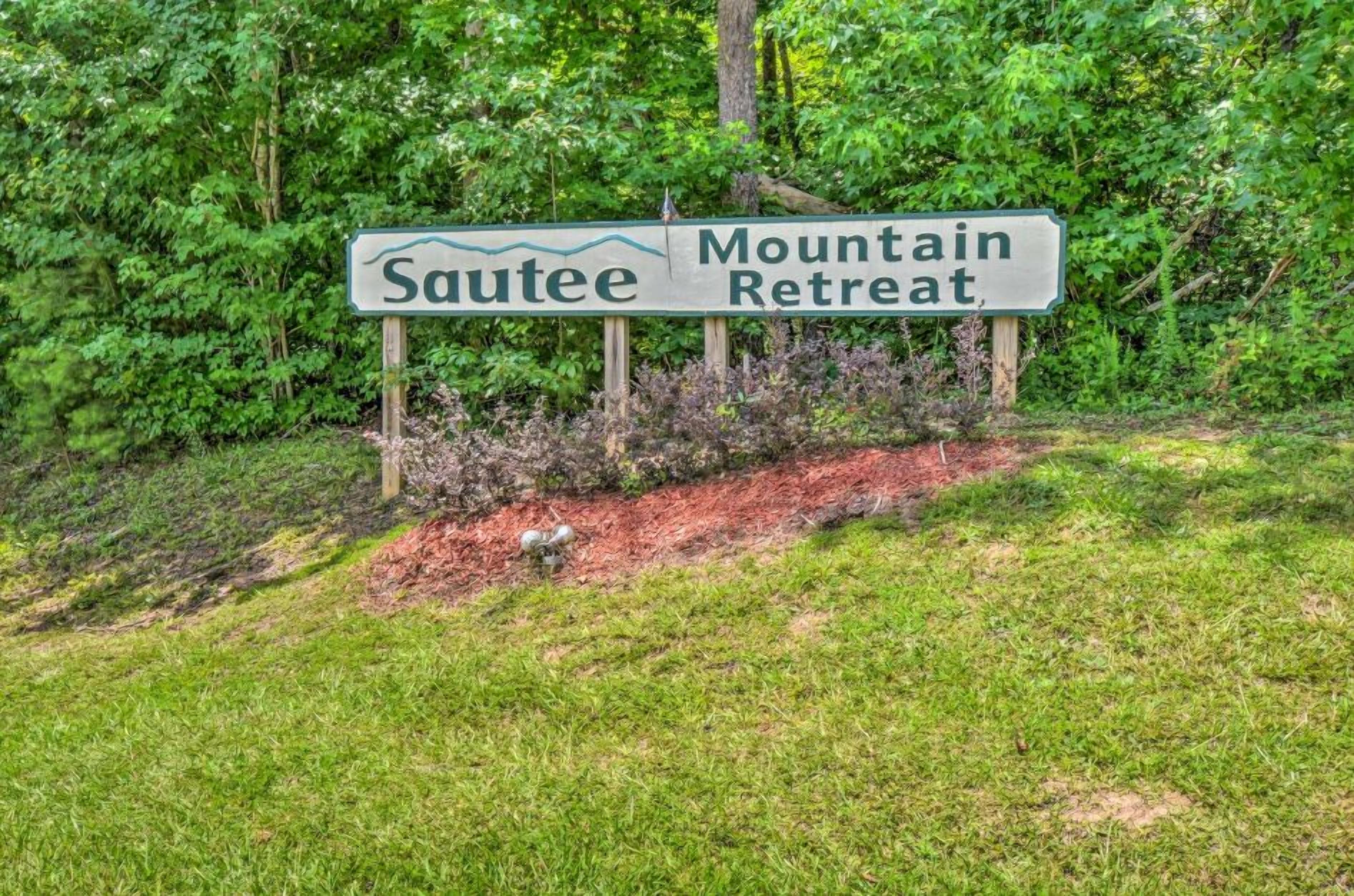 A sign for 'Sautee Mountain Retreat' with a natural backdrop.