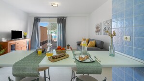 Une cuisine moderne avec une table à manger, des aliments pour le petit-déjeuner et une vue sur l’extérieur.