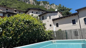 A swimming pool with a view of a mountainous landscape and residential buildings.