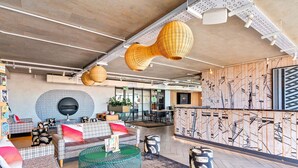 A modern interior with a seating area, a bar, and a patterned wall.