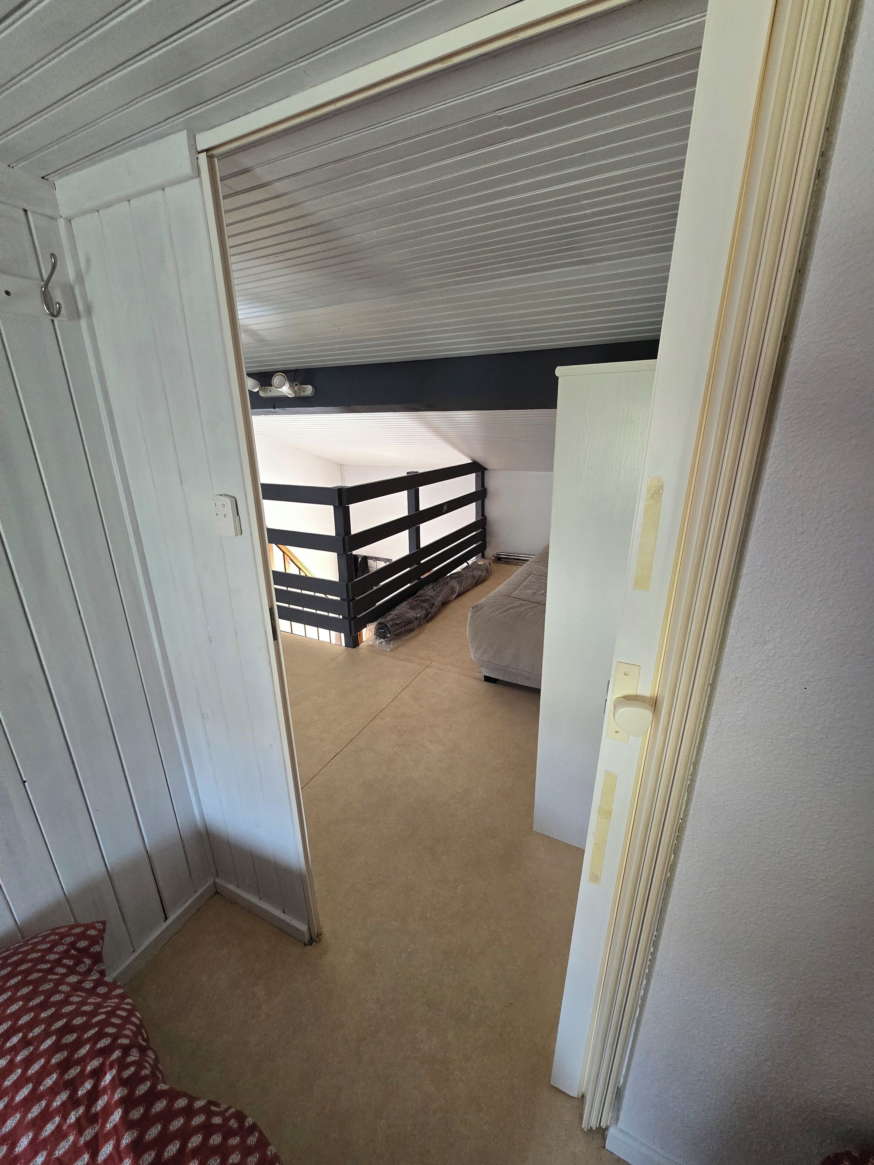 A room with a bunk bed, a door, and a carpeted floor.
