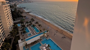 A resort with a pool area, beach, and ocean view. - Ocean view loft, Harbor 171 (Puerto Vallarta)