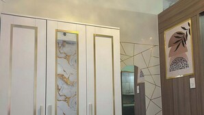 A bedroom with a wardrobe, a mirror, and a bed. - Misty Dream Condostay (Pasay City)