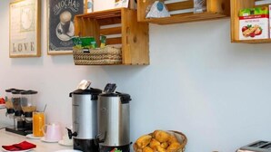 Una colazione a buffet con macchine per il caffè, croissant e diverse creme spalmabili.