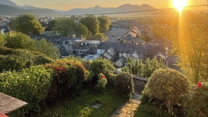 A residential area with houses, trees, and a clear sky. - Garth Celyn (Porthmadog)