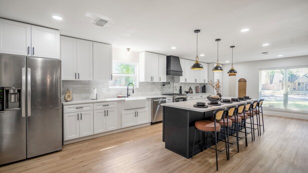 A modern kitchen with stainless steel appliances, white cabinetry, and a central island with bar stools. - Spa&Hot Tub, BBQ, Firepit, Gameroom, Western Boots (Houston)