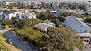 A coastal residential area with houses, a swimming pool, and a view of the ocean. - Camp Carolina 3BR 2BA home with private pool close to beach! (Isle Of Palms)