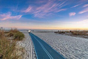 A sandy beach path leading to the ocean, with a clear sky and distant horizon. - Coastal Escape 2-Min Walk to Beach & Coligny Plaza (Hilton Head Island)
