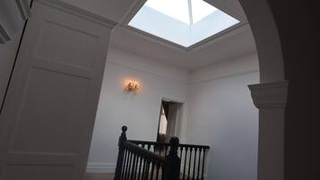A staircase with a skylight leading to an upper level.