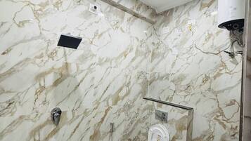 A bathroom with a toilet, sink, and ceiling fan.