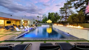 A swimming pool with lounge chairs, a bar area, and a fire feature. - Luxury 5BR Scottsdale Villa: Pool, Spa, Pickleball, Golf Simulator, Gym and More (Scottsdale)