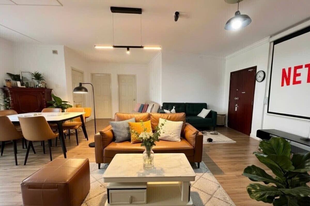 A living room with a sofa, coffee table, and a TV screen displaying 'NET'.