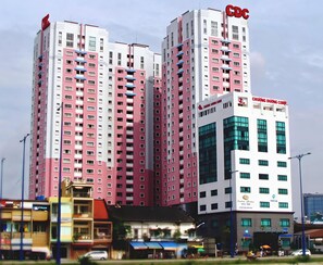 A multi-story building with a CDC sign, a Chúc Nguyên Corp. sign, and a visible entrance with a blue awning. - Central Garden (Ho Chi Minh City)