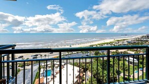 A balcony with a view of the beach and ocean. - Two Pina Coladas at San Luis Resort (Galveston)