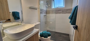 Shower, hair dryer, towels, toilet paper