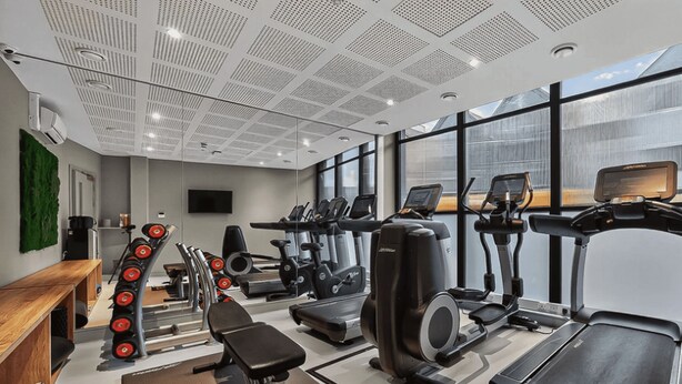 A modern gym with treadmills, elliptical machines, and free weights. - Student Only The Parade (Cardiff)