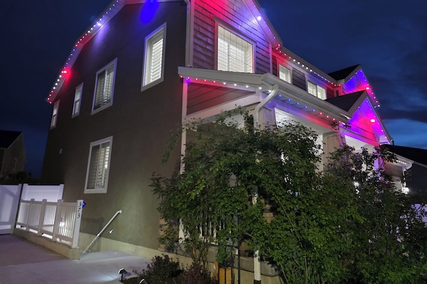 Festive red, white, and blue lights glow on this modern home –ideal for July 4th