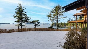 A snow-covered patio with a view of a lake and trees. - Hot Tub & Whale Watching! Scenic Sitka Escape (Sitka)