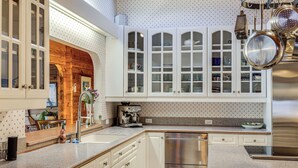 A kitchen with white cabinets, stainless steel appliances, and a granite countertop. - Hot Tub & Whale Watching! Scenic Sitka Escape (Sitka)