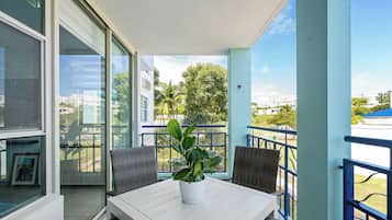 Luxury Apartment, Balcony, Pool View | Outdoor dining