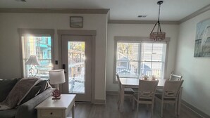 A spacious living room with a sofa, a small table, and a dining area with chairs. - Spacious 6-bedroom house in wonderful Ocean Lakes (Myrtle Beach)