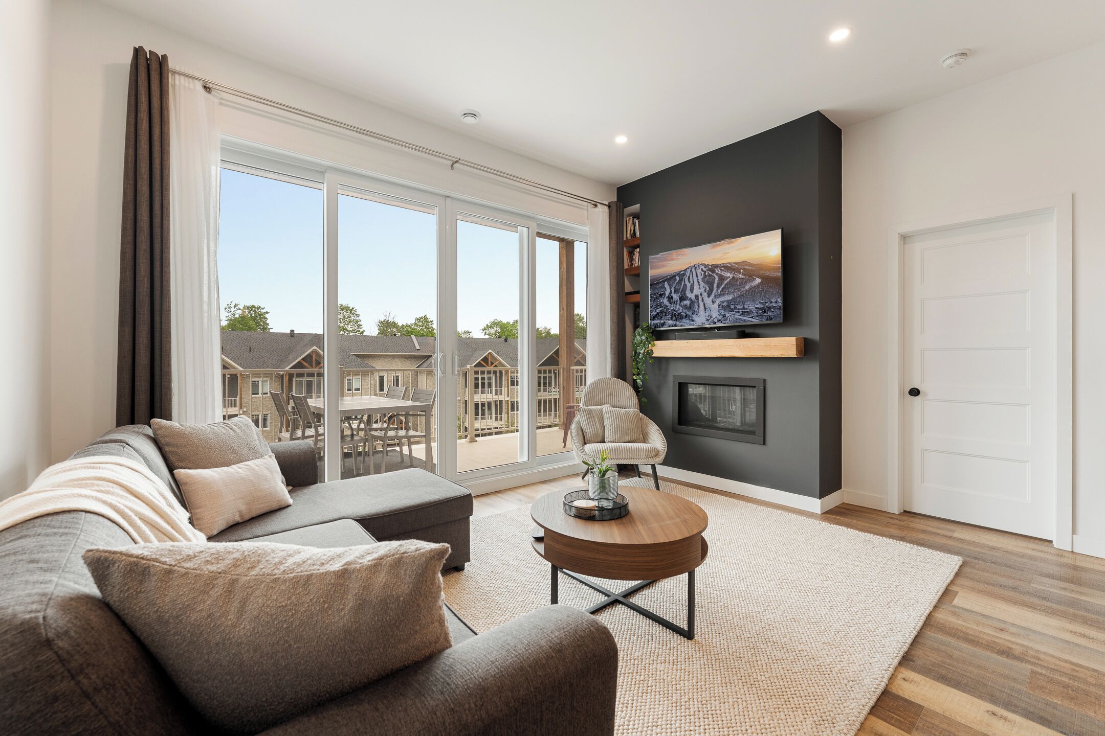 A modern living room with a sofa, coffee table, and a fireplace.
