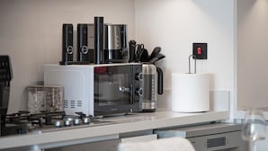 A modern kitchen with a microwave, toaster, and coffee maker on the countertop. - Luxury 2BR Burj Khalifa View Dubai Mall (Dubai)