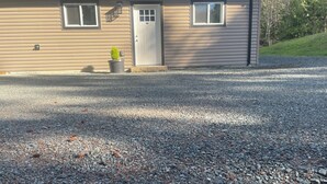 A house with a gravel driveway, a front door, and a small potted plant. - Quiet getaway in the forest close to beach/lakes/Mt Washington and great food. (Qualicum Beach)