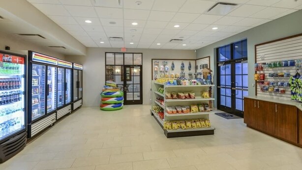 A grocery store interior with refrigerated cases, snack shelves, and a display counter. - Modern 5Br Downstairs Room, Pool & Lazy River 2402 (Kissimmee)