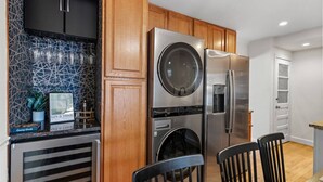 A modern kitchen with stainless steel appliances, a built-in oven, and a wine rack. - Family-Friendly 3BR Home Near DC (Arlington)