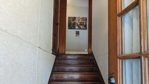 A wooden staircase leading to a room with a door on the right. - Upper 2-bedroom apartment near down-town Chippewa Falls (Chippewa Falls)