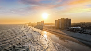 A beach with buildings in the background. - Newly Updated Ocean View 2BR/2BA • 50 Steps to Beach • Walk to Apache Pier (Myrtle Beach)