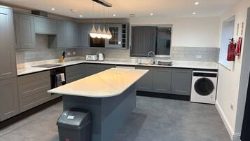 Fridge, microwave, cookware/dishes/utensils, dining tables