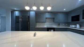 Fridge, microwave, cookware/dishes/utensils, dining tables